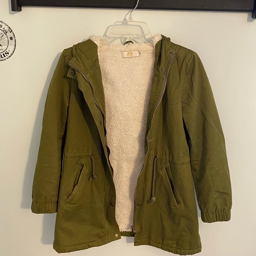 Woman’s green fuzzy jacket